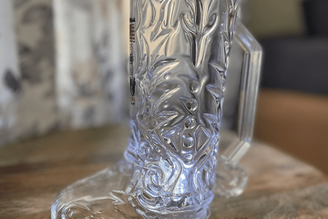 a glass of wine sitting on top of a wooden table