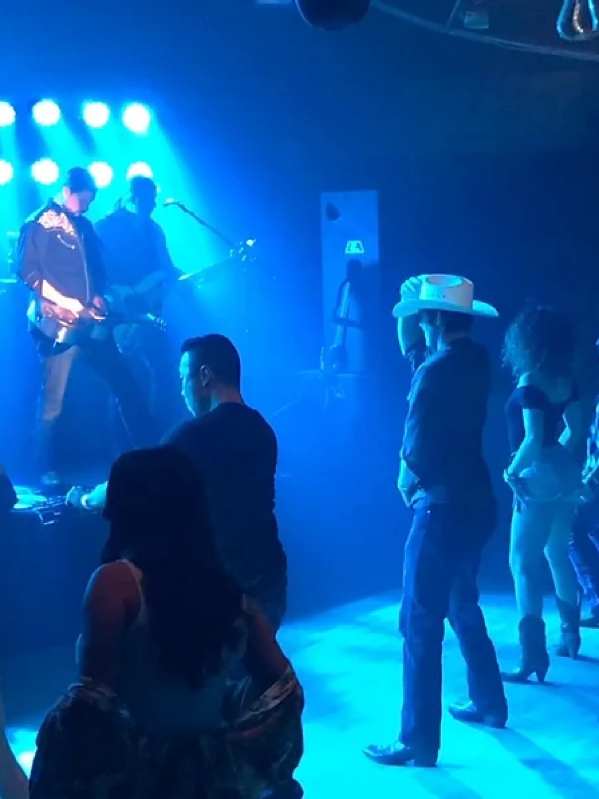 a group of people on a stage in front of a crowd