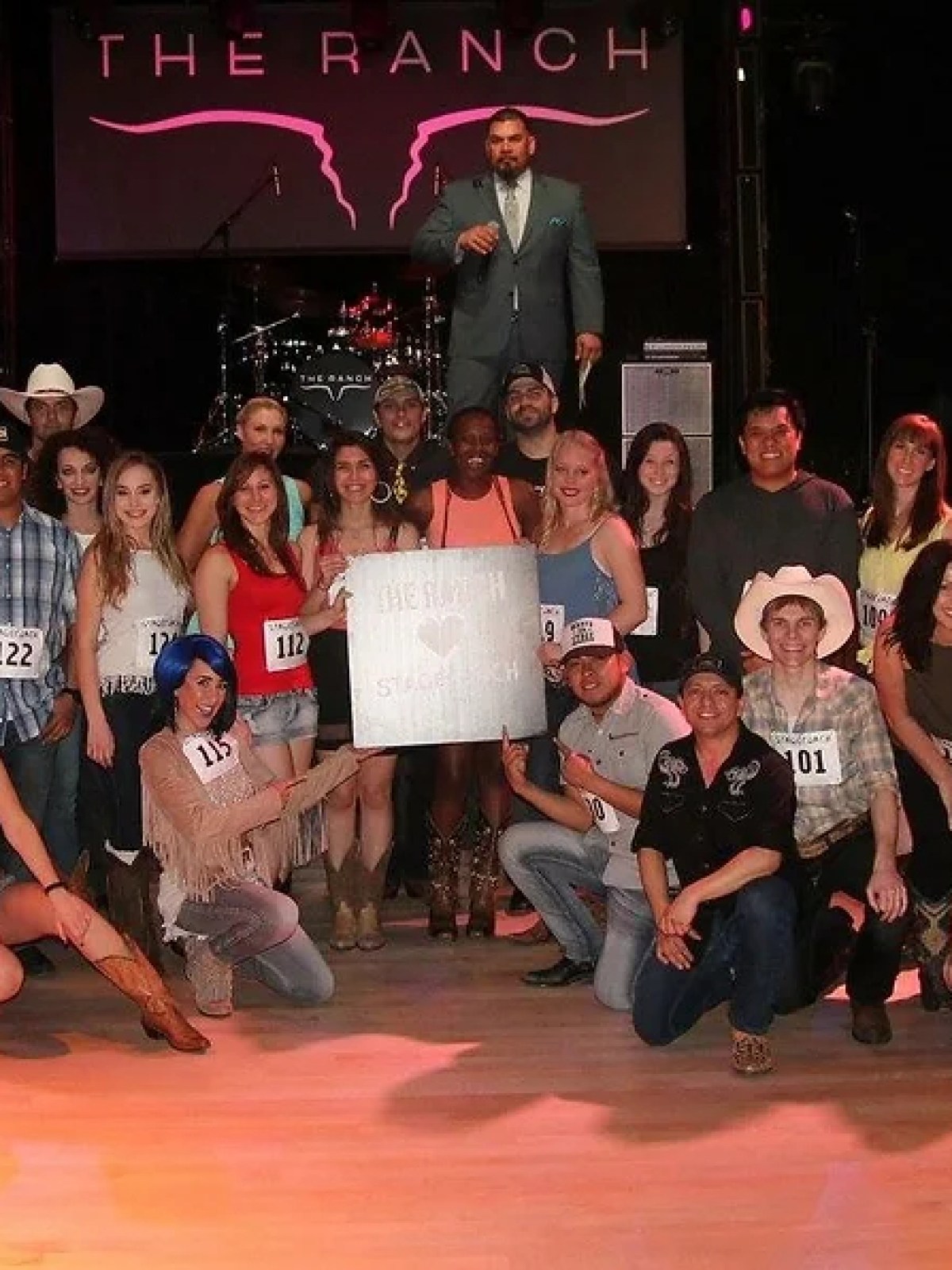 a group of people standing in front of a crowd posing for the camera