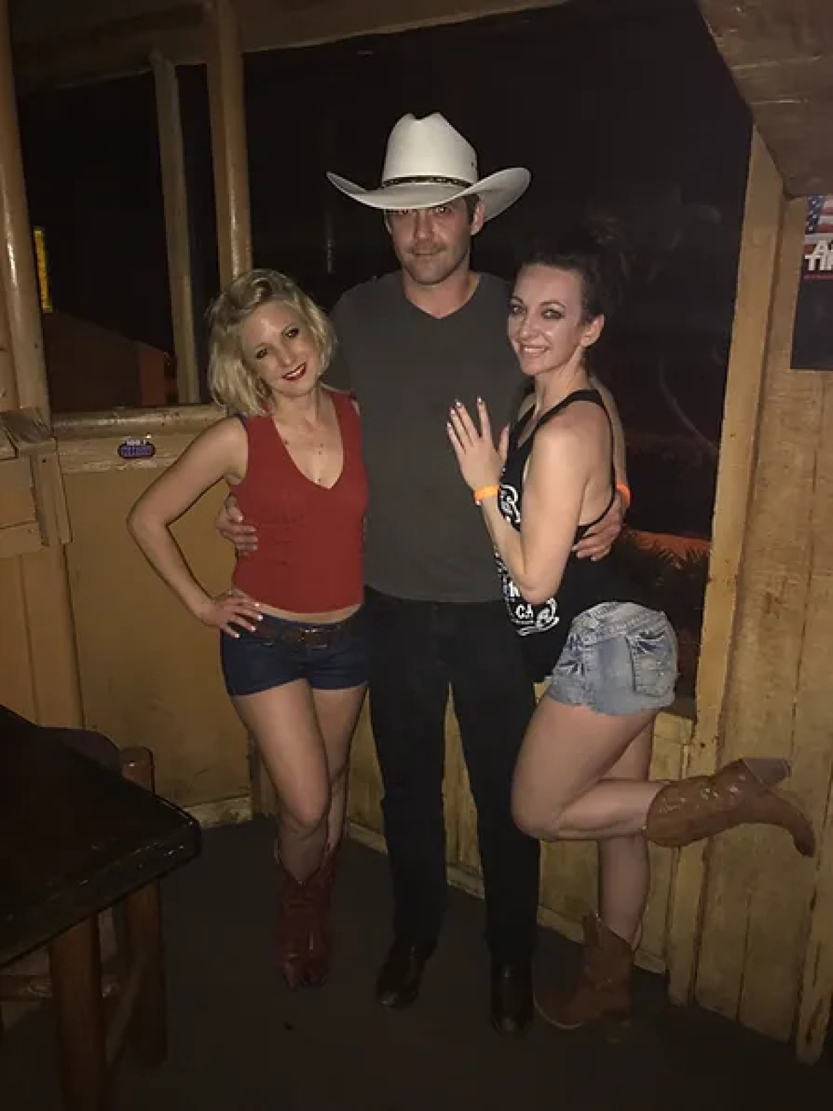 a woman standing in front of a group of people posing for the camera