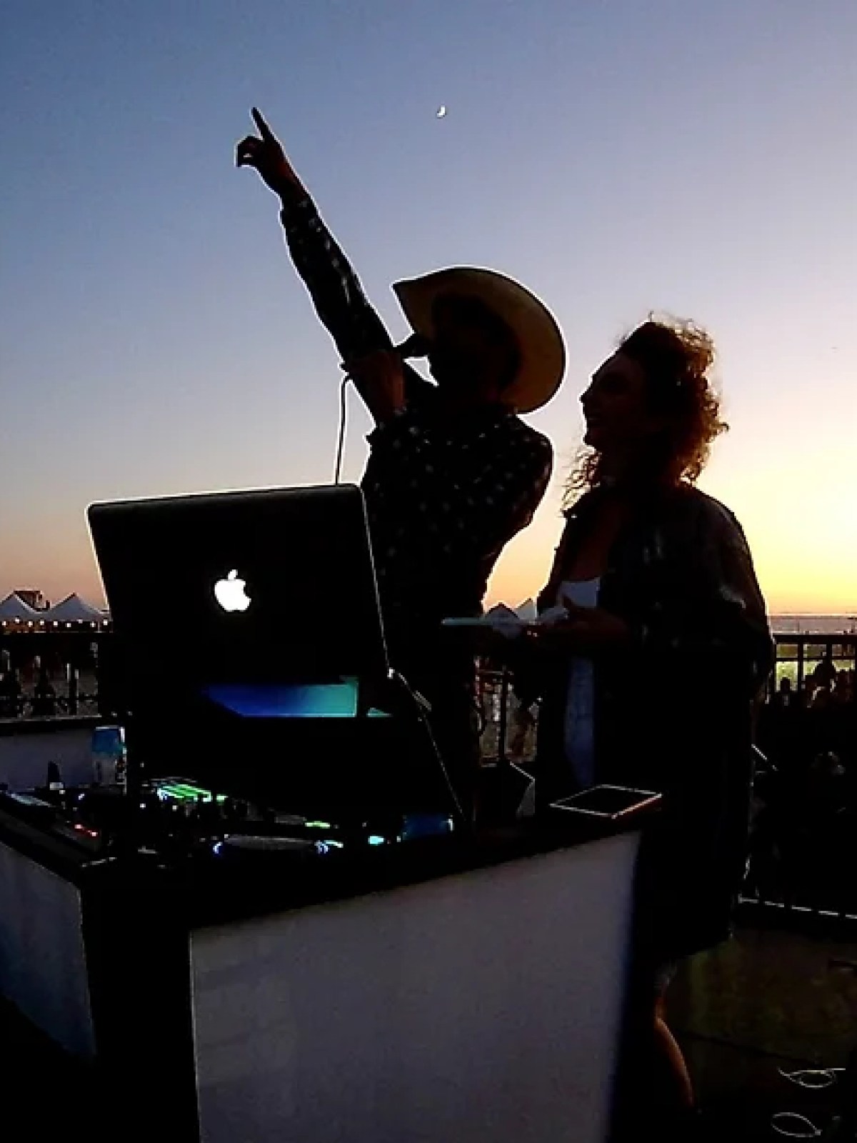 a person sitting at a table in front of a laptop