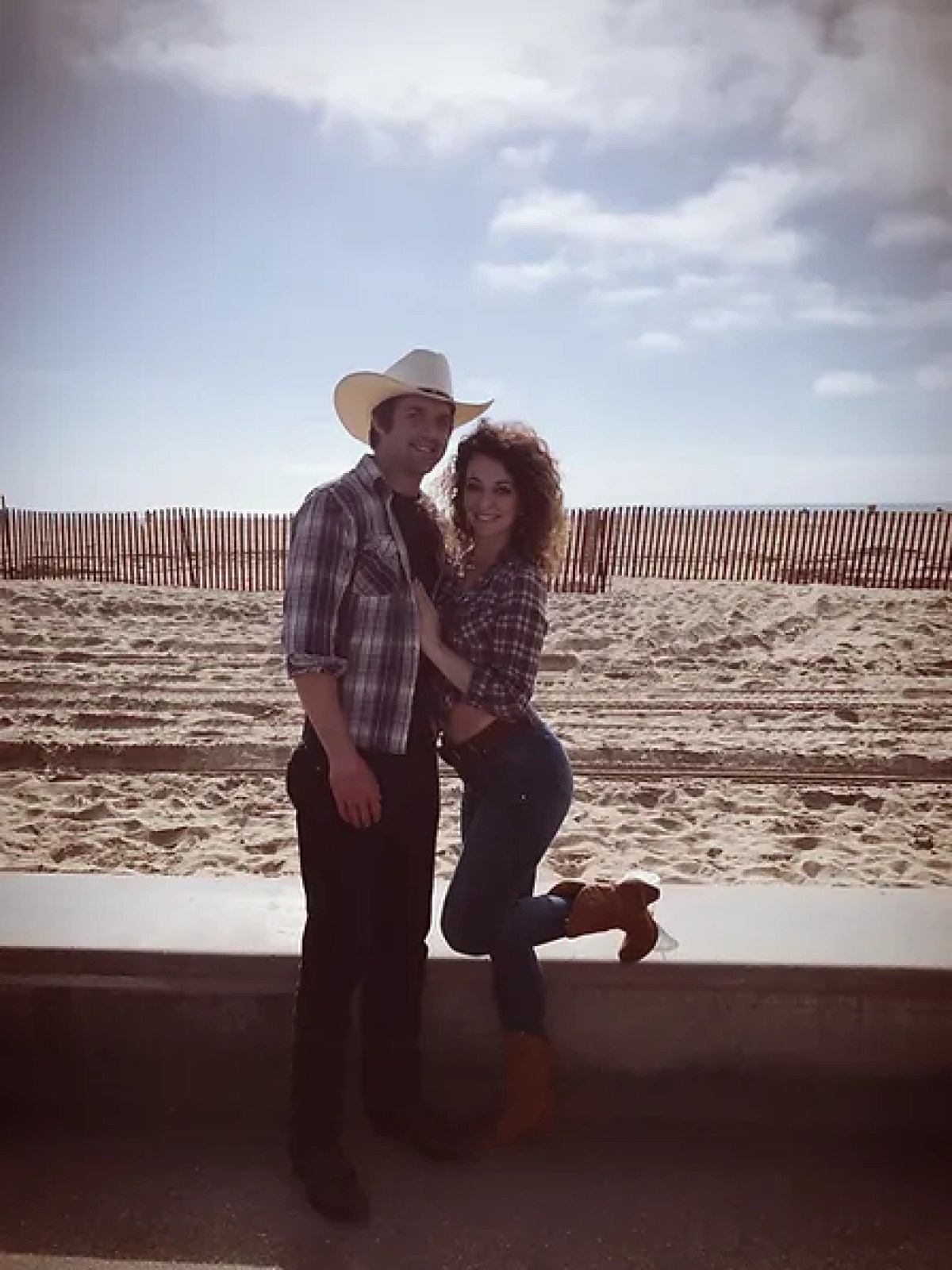 a man and a woman sitting at a beach