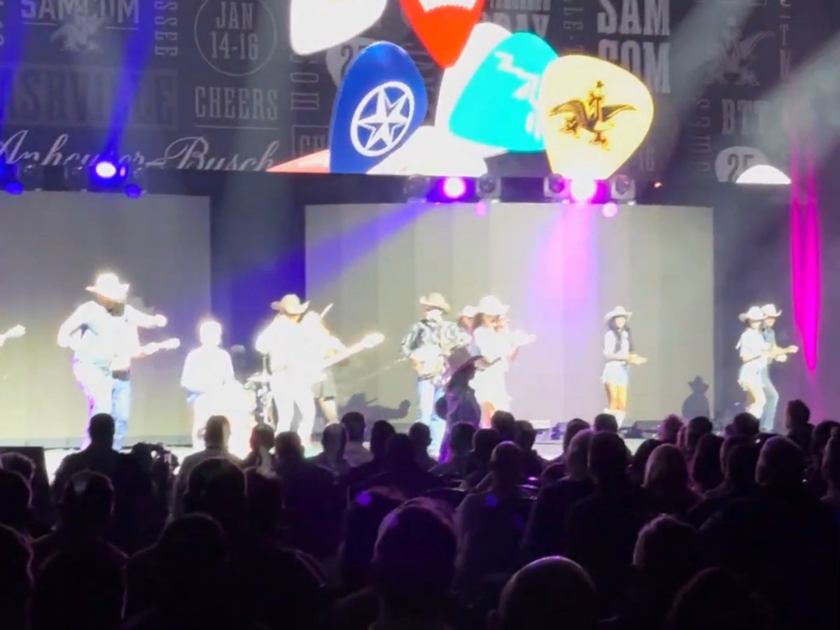 a group of people on a stage in front of a crowd