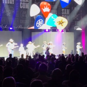 a group of people on a stage in front of a crowd