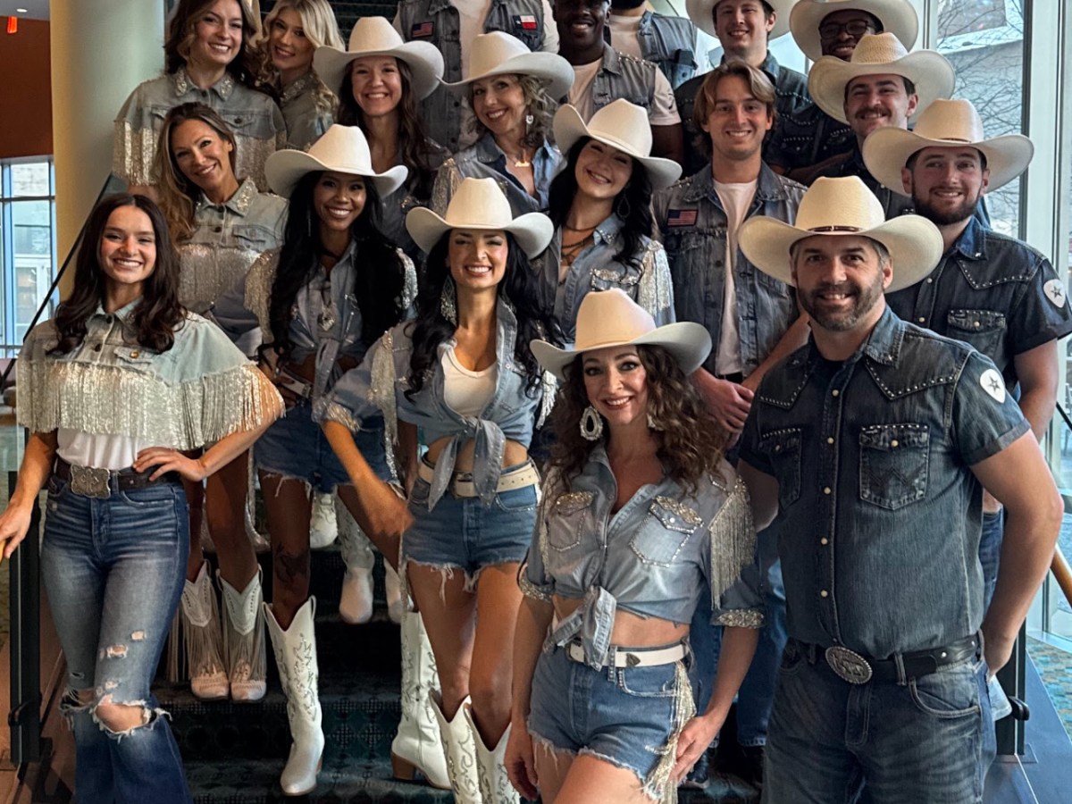 Judy Del Giudice et al. standing in front of a crowd posing for the camera