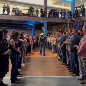 a group of people standing in front of a crowd