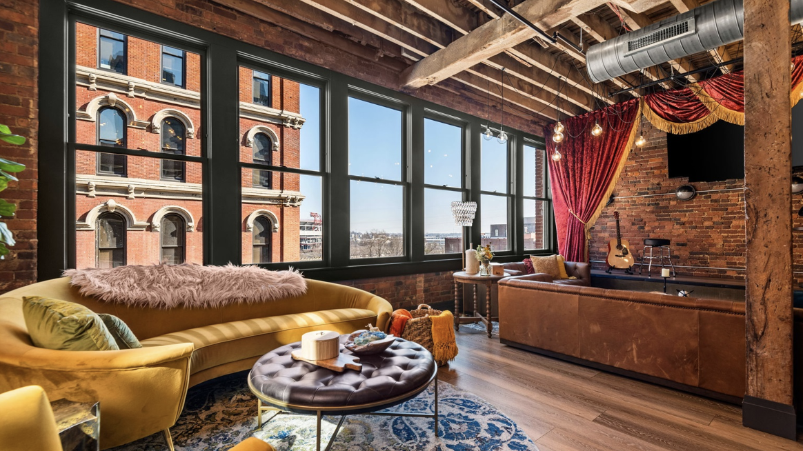 a room filled with furniture and a large window